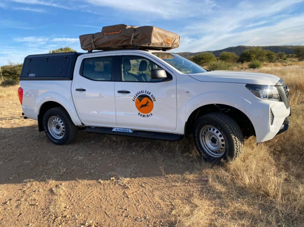 Nissan Navara 2022 4x4 double cab from right side with one roof tent