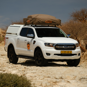 Ford Ranger 4x4 doublecab pickup truck with rooftop tent on 4x4 trail