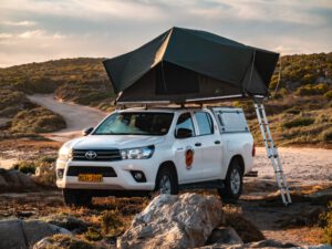 Automatic Toyota Hilux 4x4 rental car with standard rooftent open