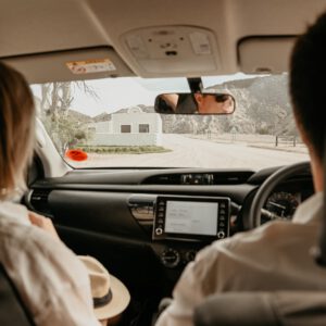 Couple driving inside a Toyota rental car in Namibia