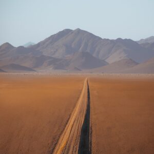 Sand road leading towards mountain in Namibia