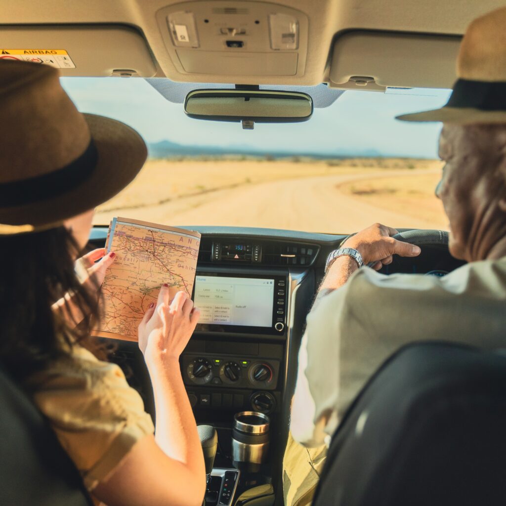 Woman and man infront in car looking at map 2000x2000