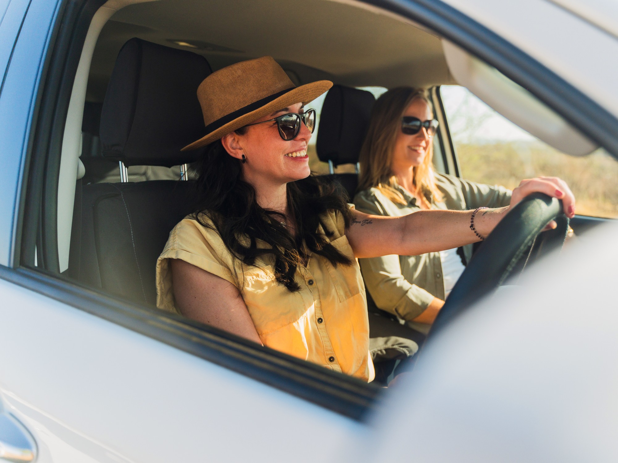 Two woman driving rental car